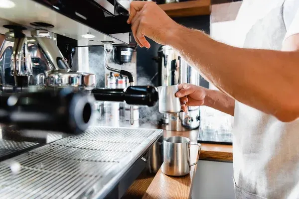 Stock Photo Partial View Barista Holding Metallic Milk Mug Steamer Coffeemaker Blurred